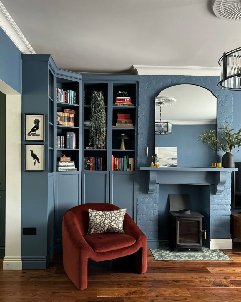 A vibrant red sofa and soft blue walls combine for a lively yet calming space.