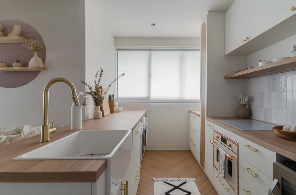 Minimalist boho kitchen with soft neutrals and brass details.
