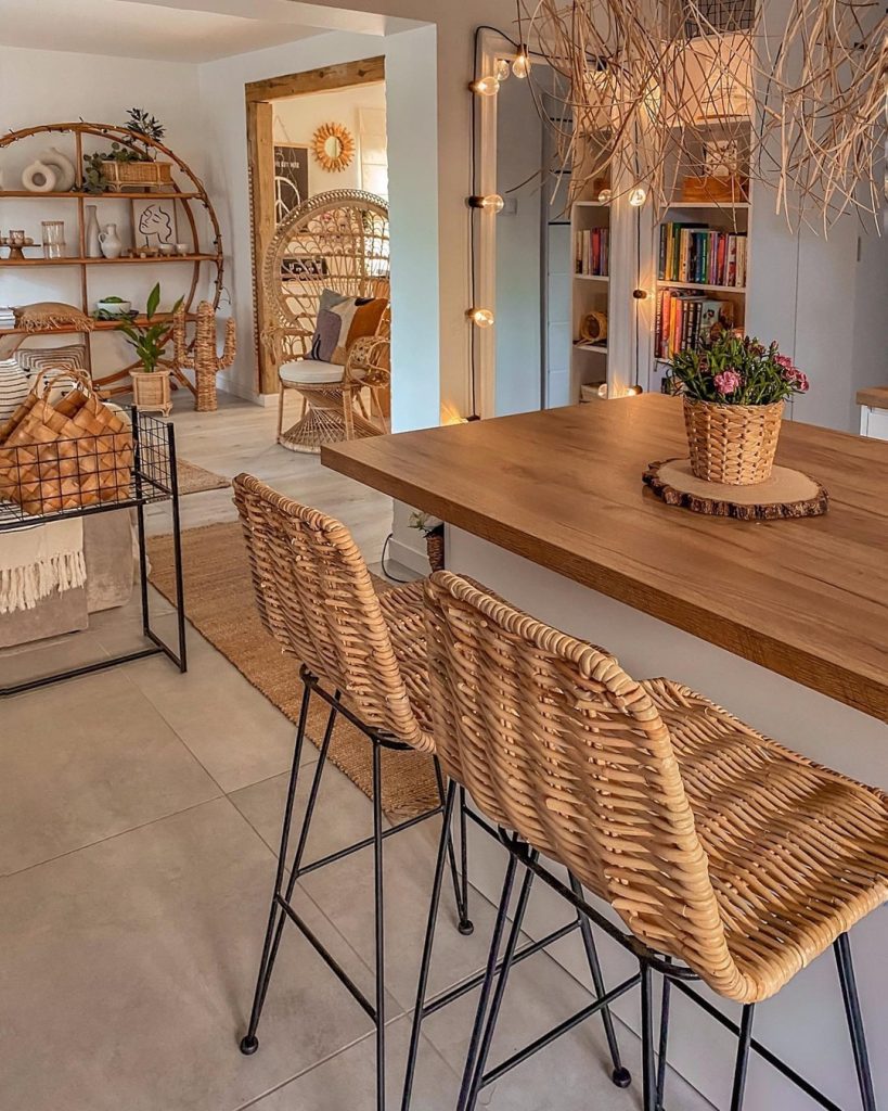 Nature-inspired cozy kitchen with open shelving, warm wood accents, and lush plants.
