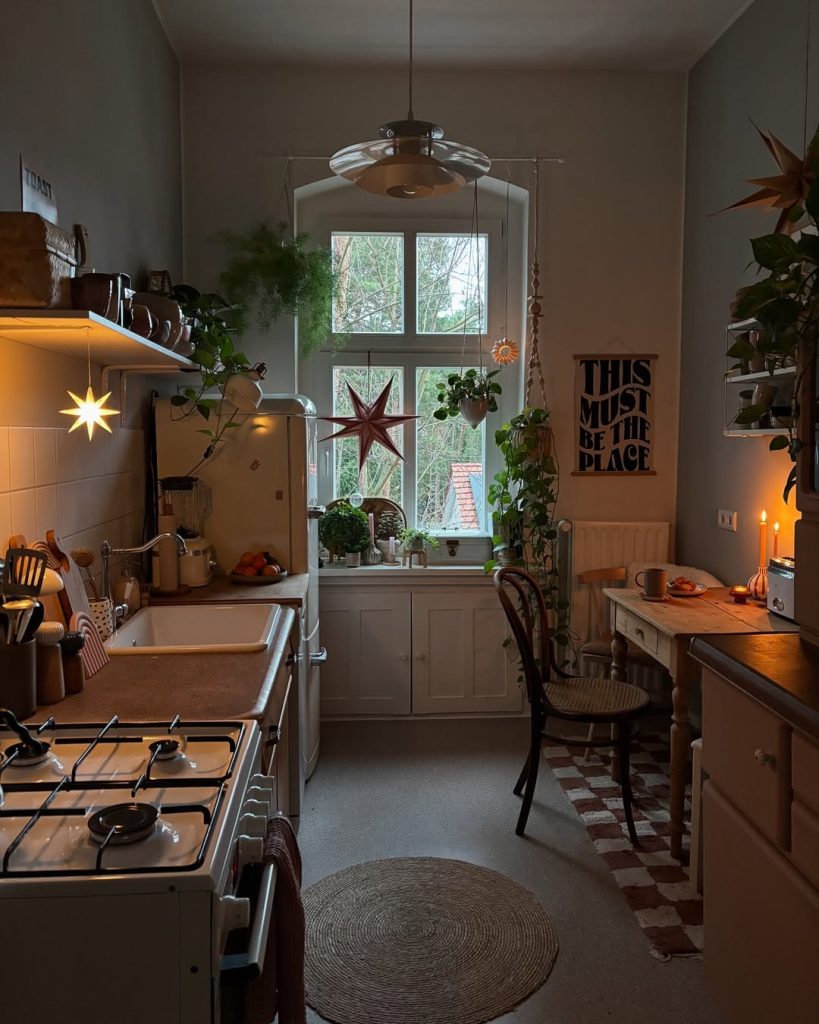 Rustic farmhouse cozy kitchen with exposed brick, wooden countertops, and fresh greenery.
