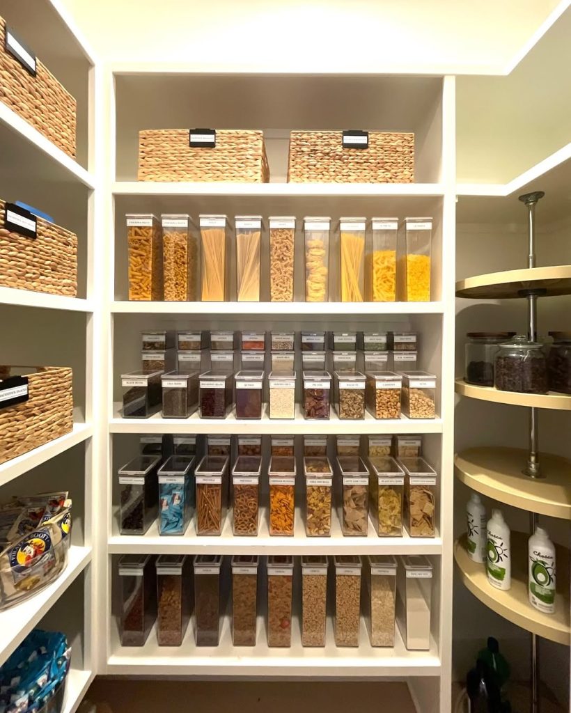 Label-perfect pantry with clear storage bins and woven baskets.
