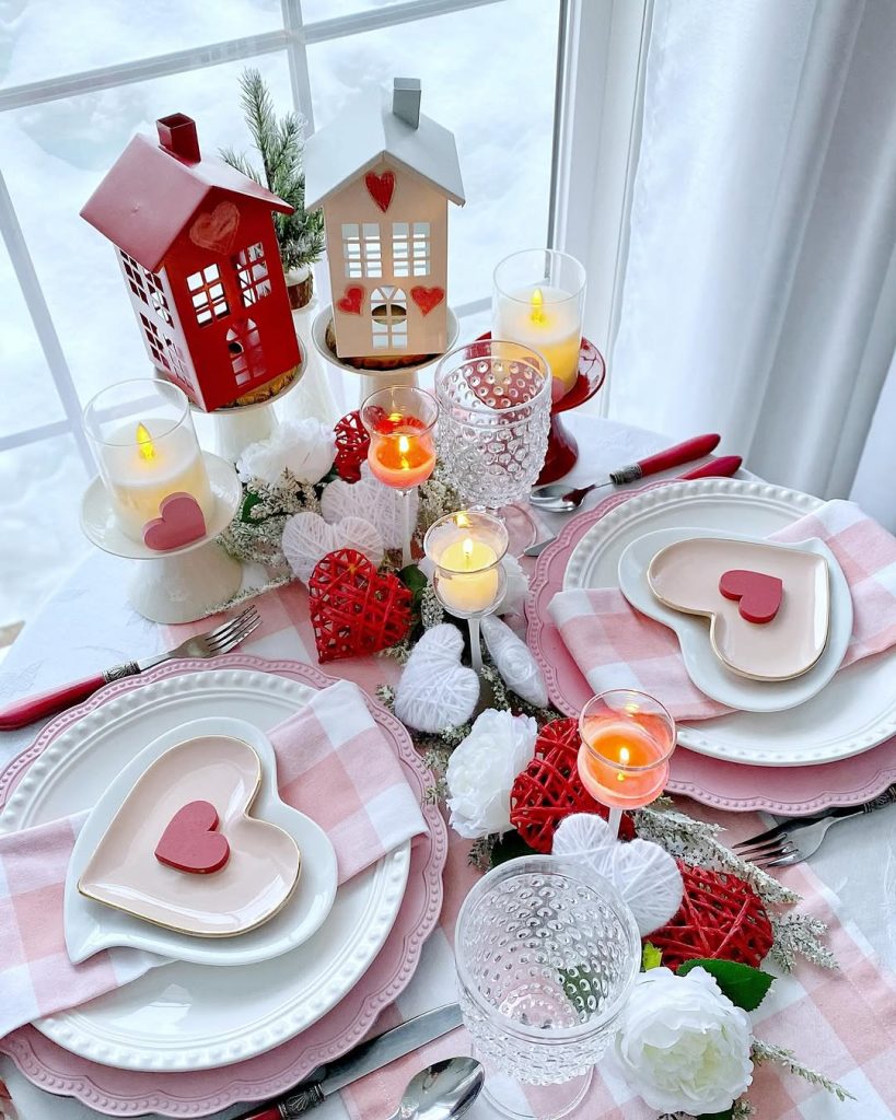 Winter-inspired romantic table setting with heart-shaped plates and lantern decor.
