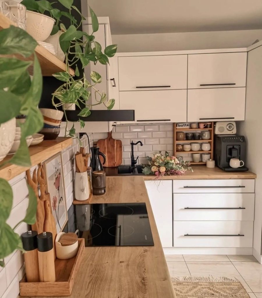 Modern boho kitchen with wooden countertops and trailing plants.
