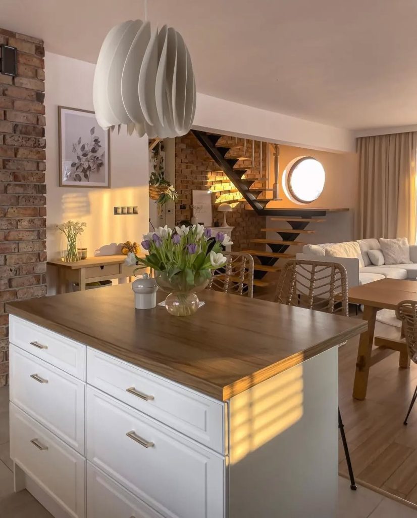 Warm and modern boho kitchen with exposed brick and pendant lighting.
