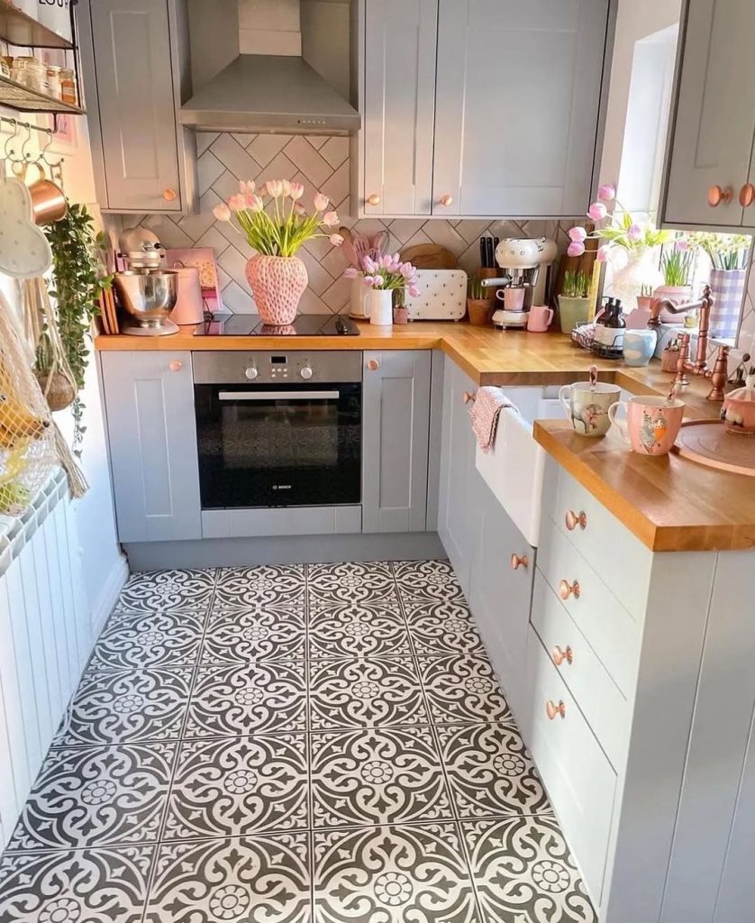 Boho modern cozy kitchen with white cabinets, woven wall decor, and warm wood tones.
