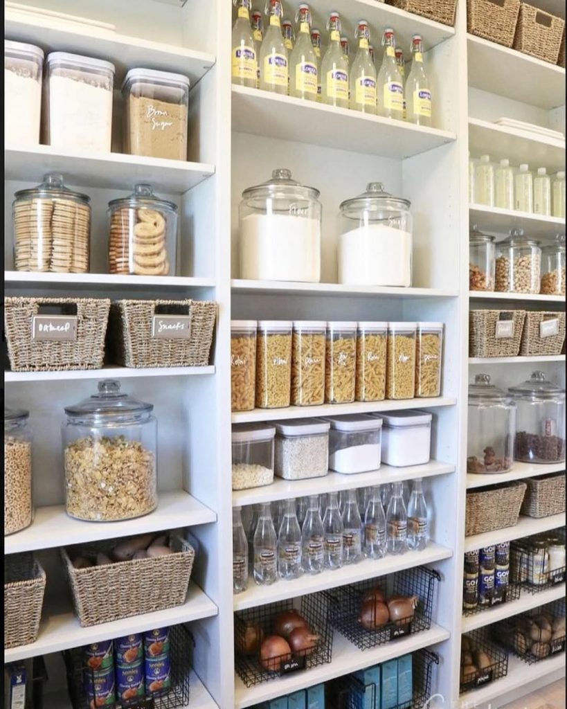 Bright and airy pantry with woven baskets and neatly labeled containers.
