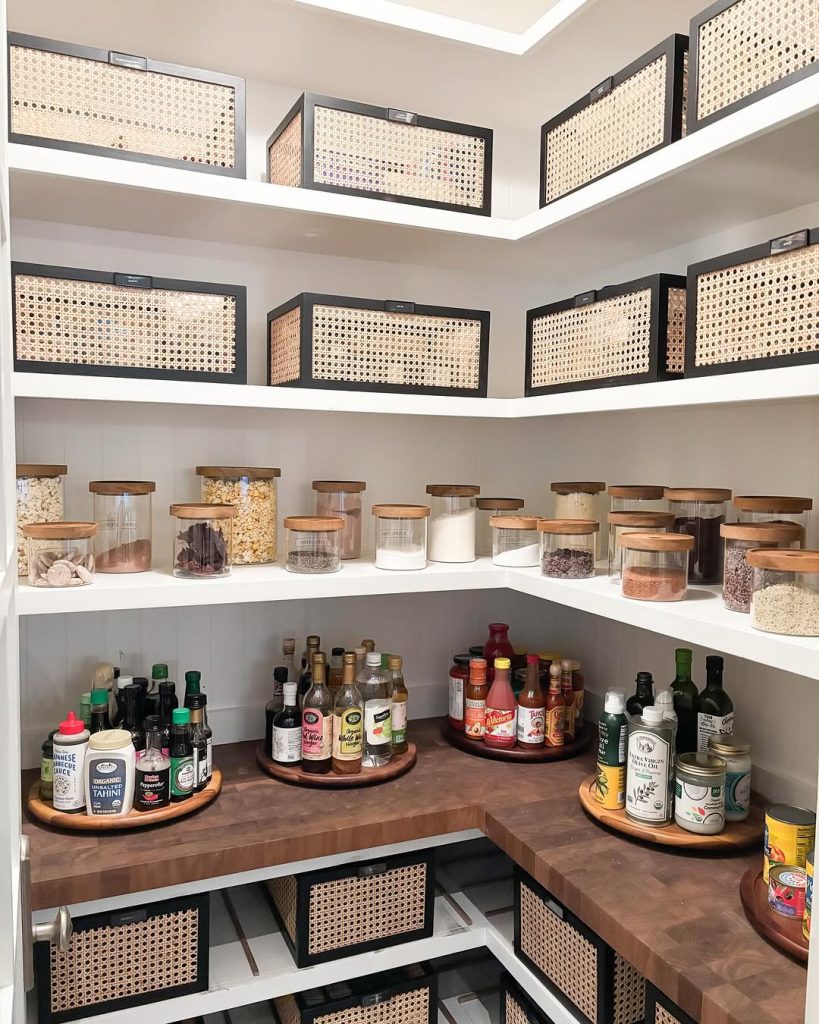 Chic pantry with stylish black woven baskets and glass storage jars.
