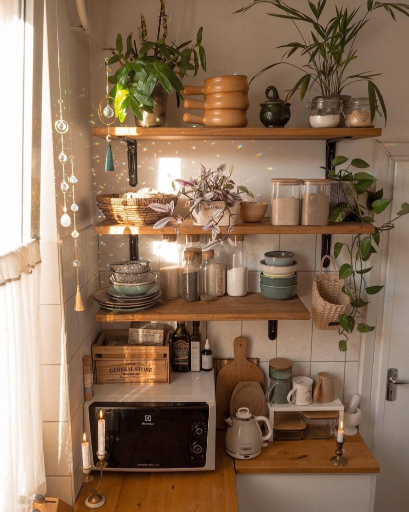 Cozy and functional boho kitchen with open shelving and plants.
