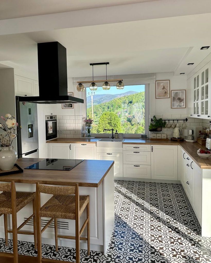 Soft and warm cozy kitchen with vintage mugs, fresh flowers, and farmhouse-style cabinets.
