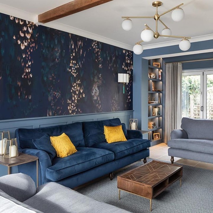 Modern navy blue living room with bold patterns and pops of vibrant color.