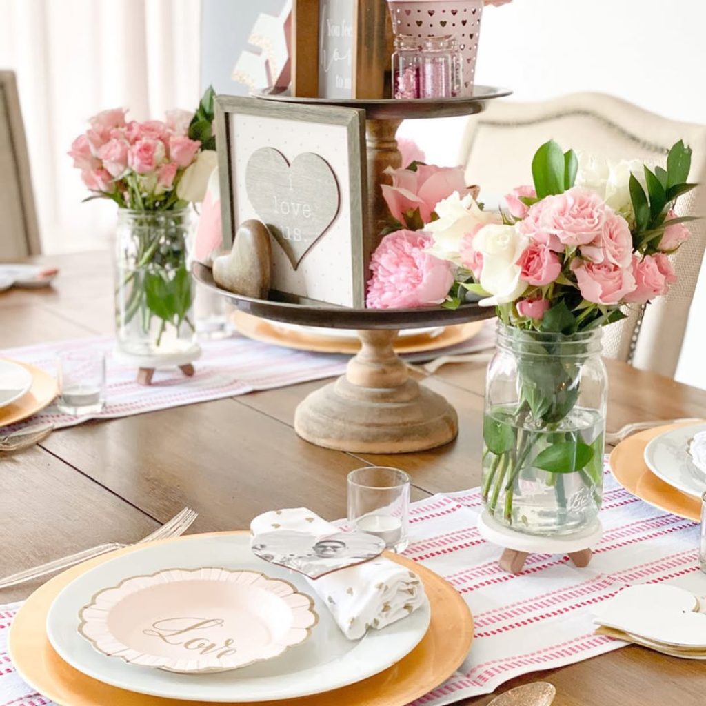 Cozy romantic tablescape with fresh blooms and a charming tiered centerpiece.
