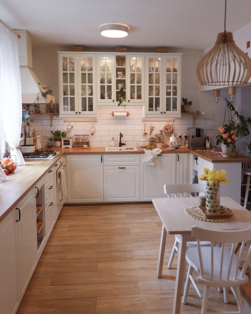 Elegant warm cozy kitchen with a small dining table, woven pendant light, and rustic charm.
