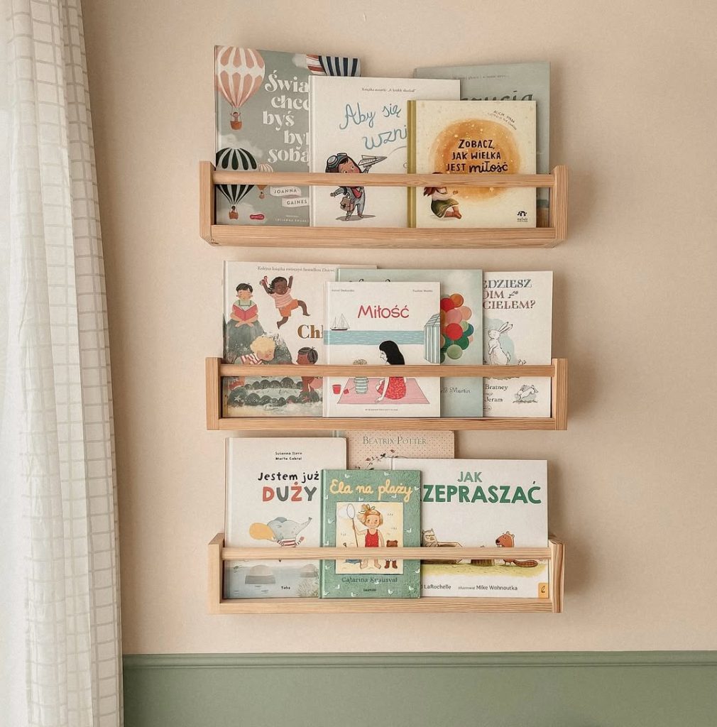 A wooden shelf displaying an array of books, showcasing various colors and sizes in an organized manner.
