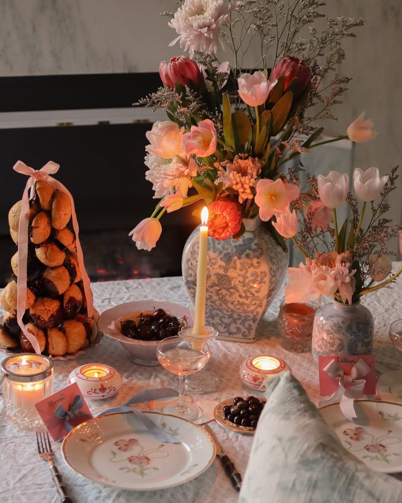 Vintage romantic table setting featuring floral china and candlelit ambiance.
