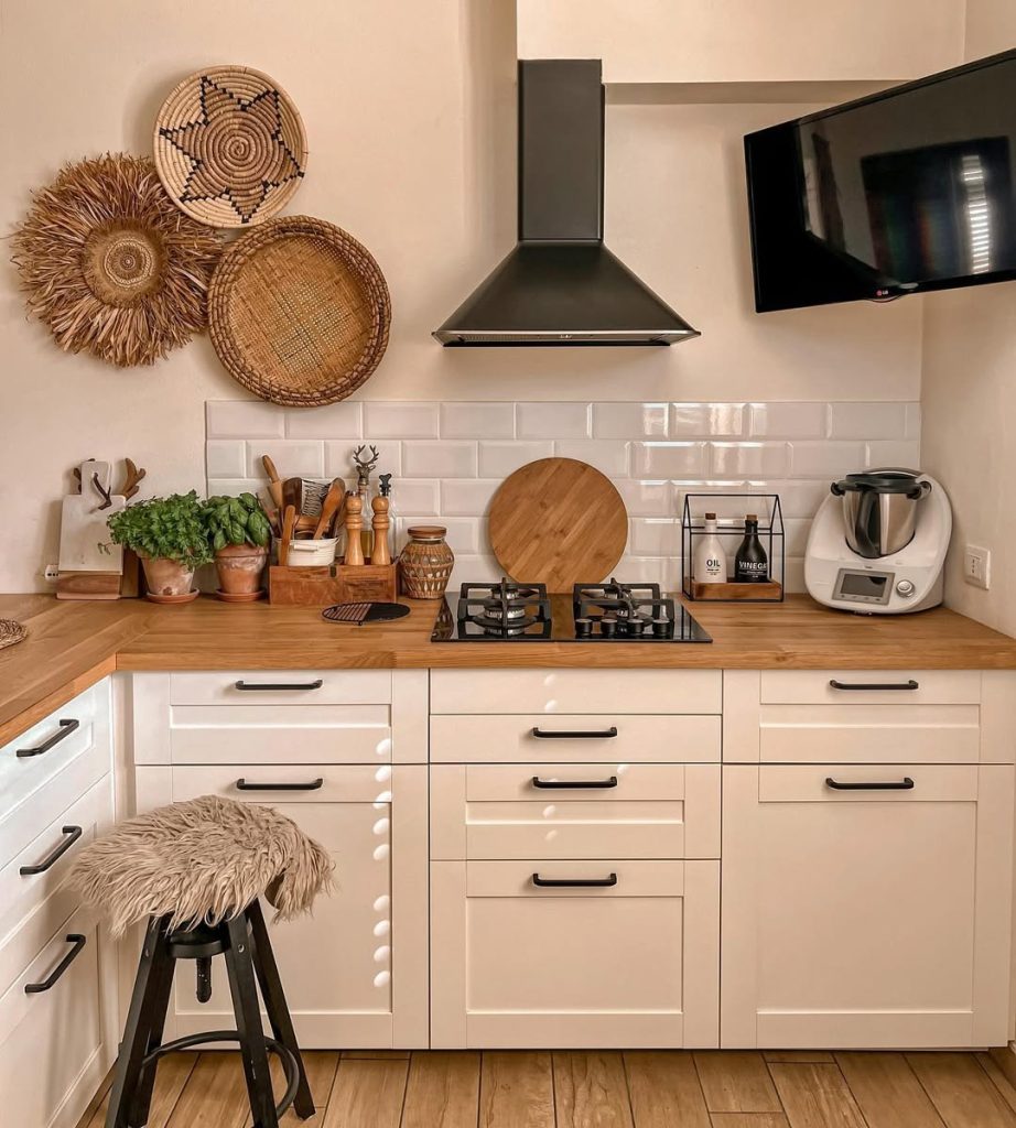 Modern boho kitchen with neutral tones and stylish black accents.
