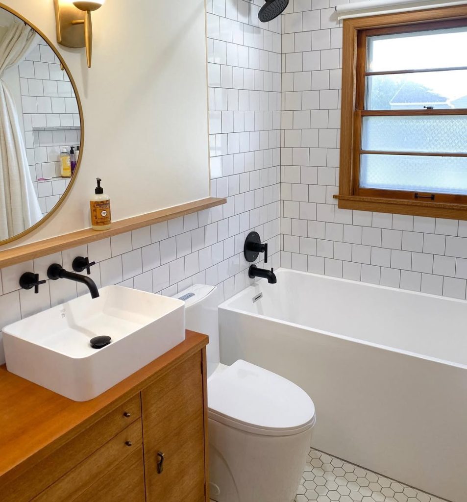 Elegant small bathroom with vintage details and modern glass shower.
