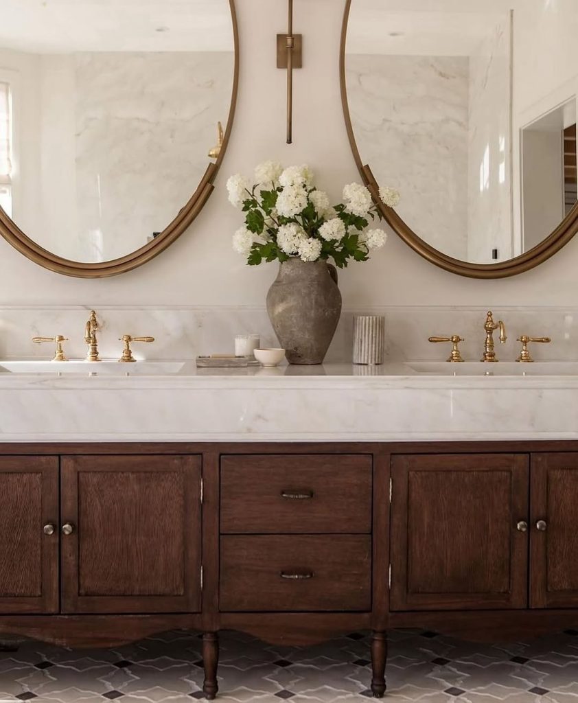 Classic-style double vanity bathroom with antique wood and brass fixtures.
