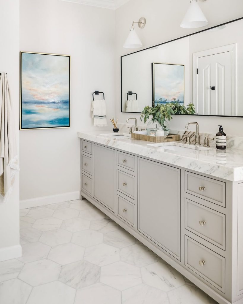 Timeless gray double sink bathroom idea with marble countertops and hex tile floors.
