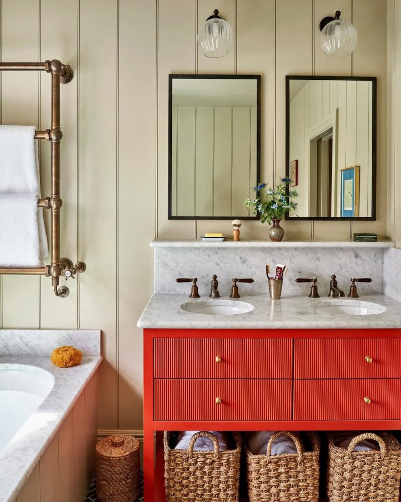 Farmhouse-style bathroom with two separate vanities and scalloped wood details.
