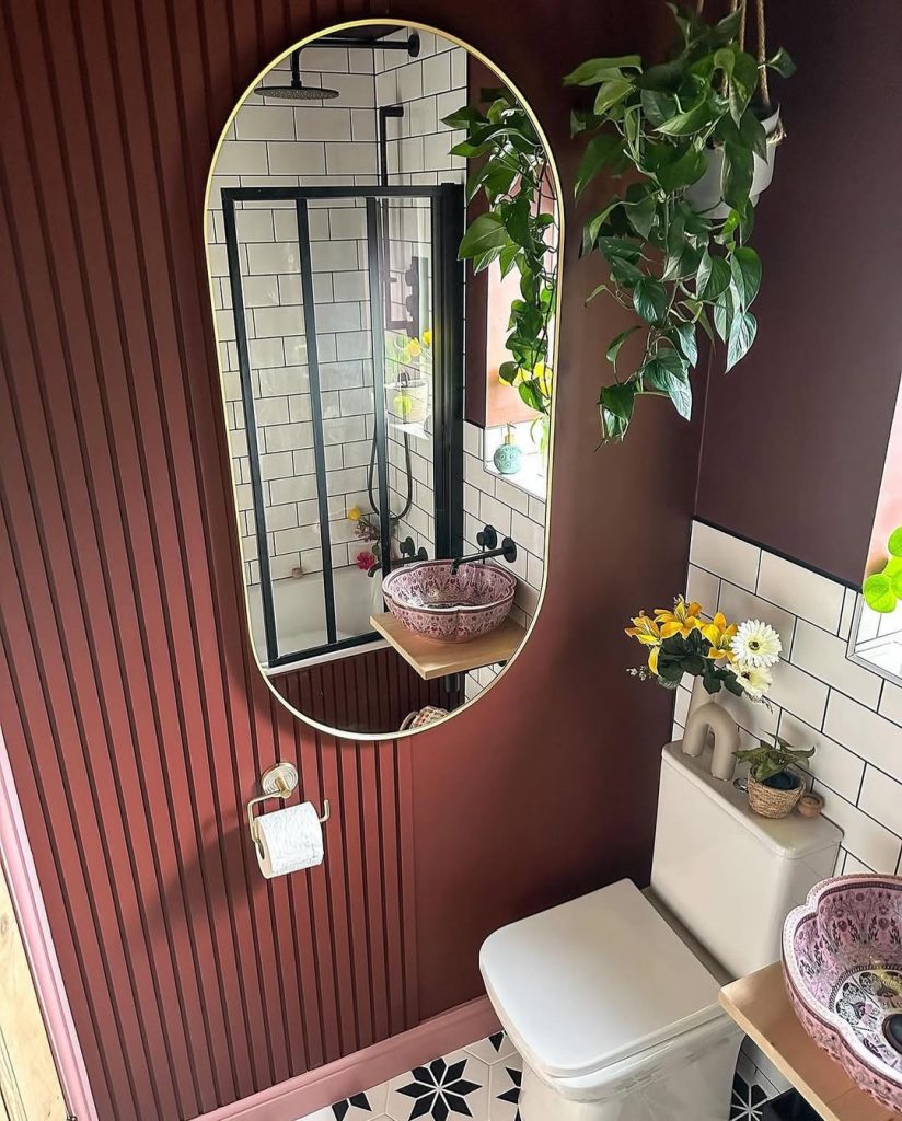 Classic white herringbone-tiled small bathroom with stylish vanity.
