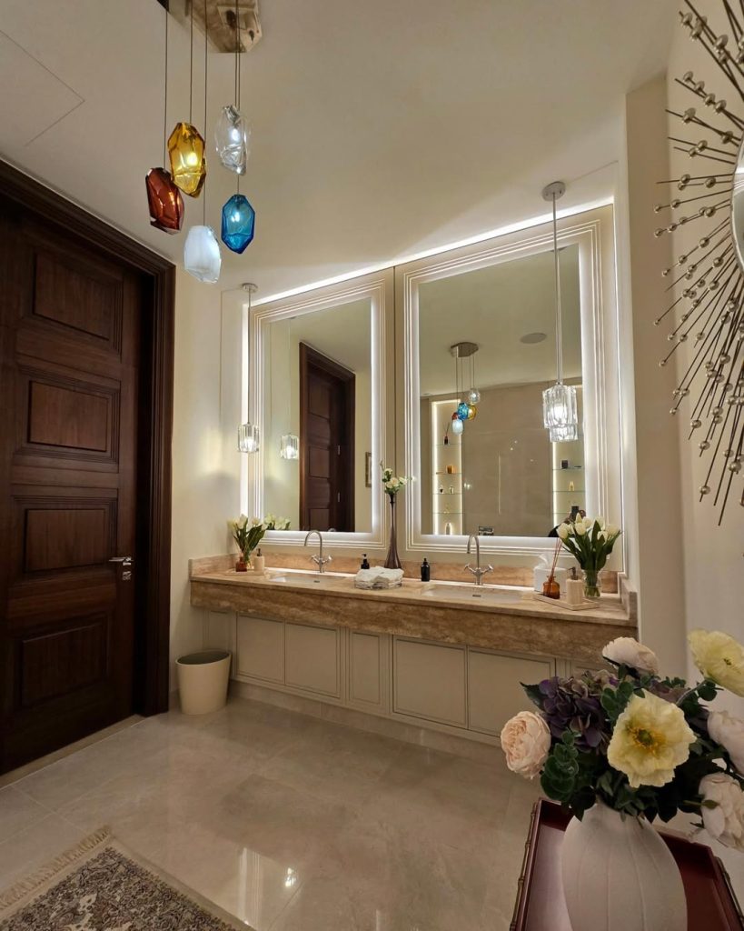 Luxurious double sink bathroom idea with statement lighting and floating vanity.
