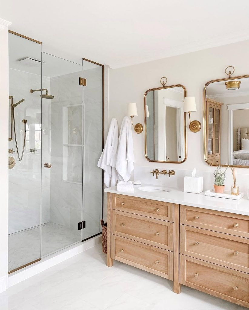 Organic and earthy double sink bathroom idea with fluted countertop details.
