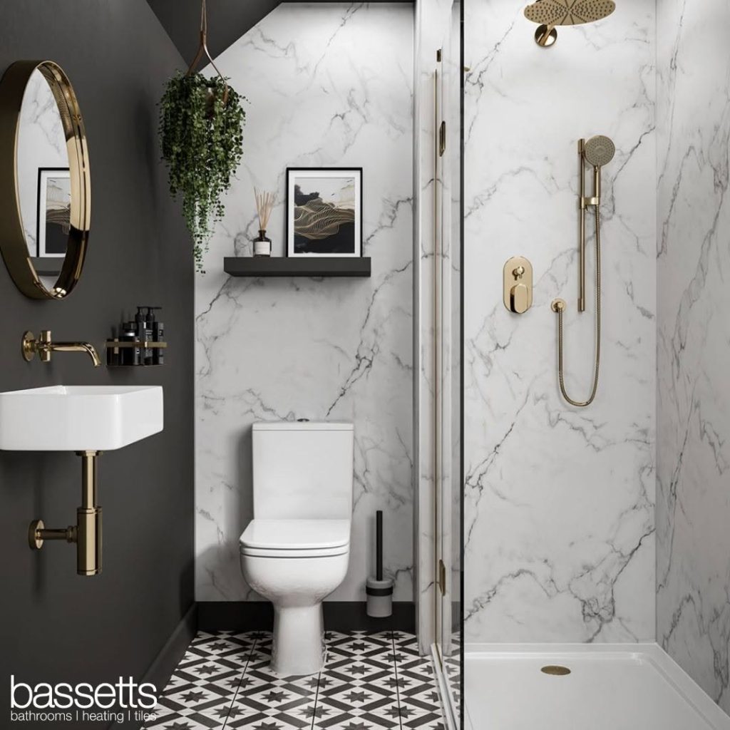 Black and white modern small bathroom with marble and gold accents.
