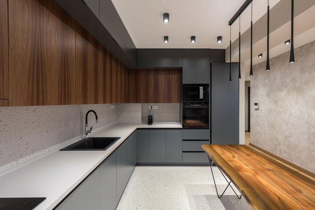 Modern two-tone kitchen cabinets with wood and matte gray finishes
