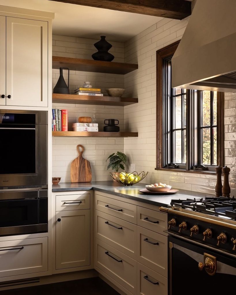 Farmhouse-style cream kitchen cabinets with black hardware and open shelves
